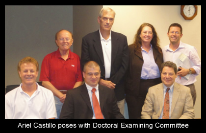 f11_art2_ariel_castillo_poses_with_doctoral_examing_committee