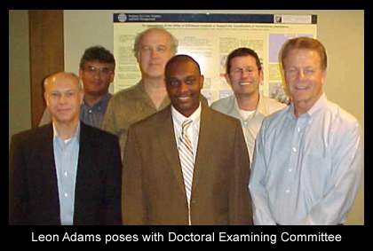 f11_art2_leon_adams_poses_with_doctoral_examining_committee