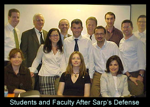 students_and_faculty_pause_for_a_photo_after_sarps_defense