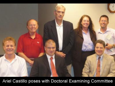 f11_art2_ariel_castillo_poses_with_doctoral_examing_committee