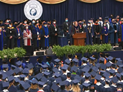 graduation, professors on stage and students in the audience