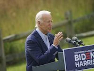President Biden speaking at podium 