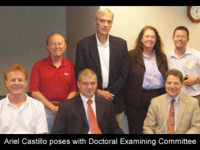 f11_art2_ariel_castillo_poses_with_doctoral_examing_committee