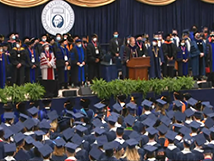 graduation, professors on stage and students in the audience
