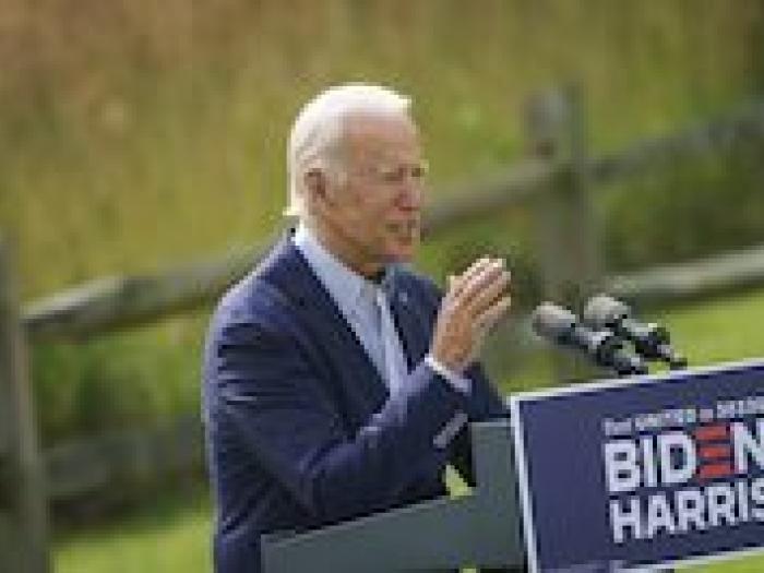 President Biden speaking at podium 